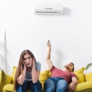 woman-and-man-dealing-with-broken-air-conditioner-OBoys-Heating-And-Air-signs-your-ac-needs-immediate-professional-services