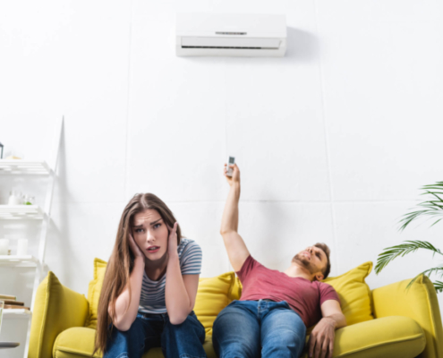 woman-and-man-dealing-with-broken-air-conditioner-OBoys-Heating-And-Air-signs-your-ac-needs-immediate-professional-services