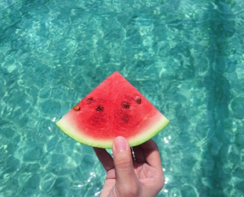 watermelon-slice-by-a-swimming-pool-oboys-heating-and-air-importance-of-hvac-maintenance-during-th-summer-season