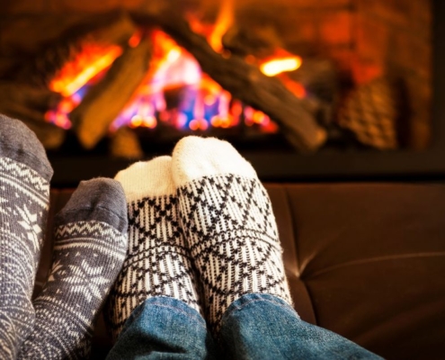 socks near a warm fireplace - O'Boys Heating & Air furnace or heat pump