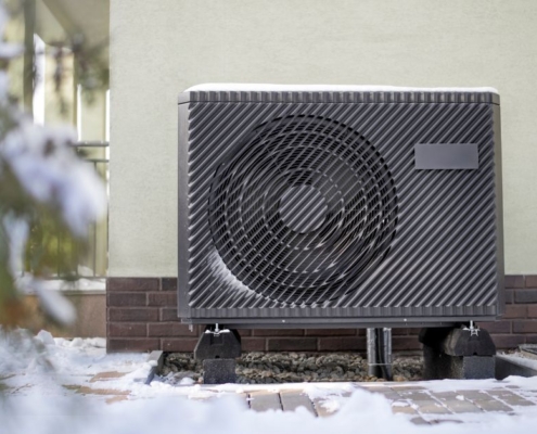 outdoor heat pump in the snow - O'Boys Heating & Air heat pump